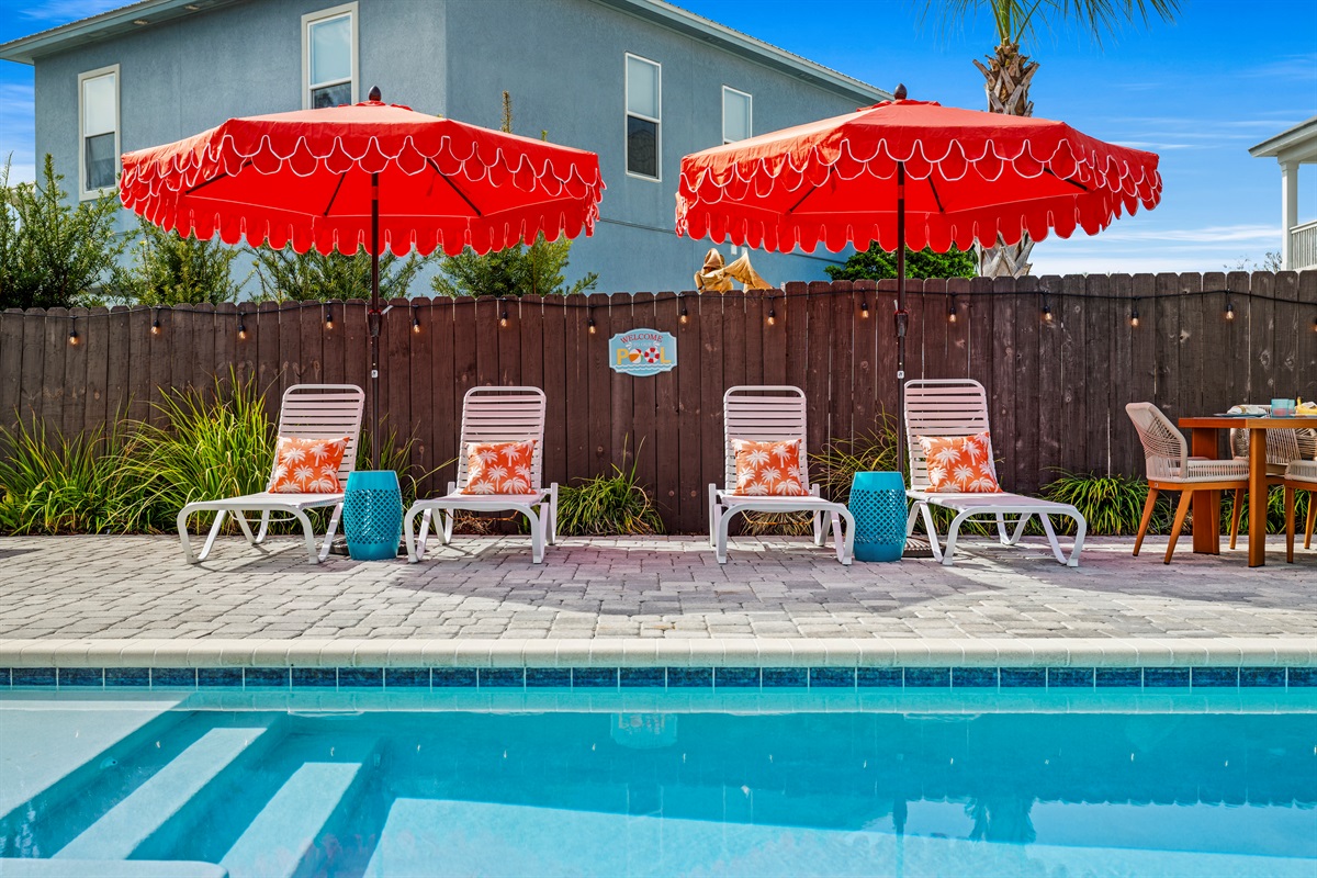 Claim your lounger and let vacation begin. Bright umbrellas, comfy chairs, and a sparkling pool create the perfect spot to unwind after a beach day.