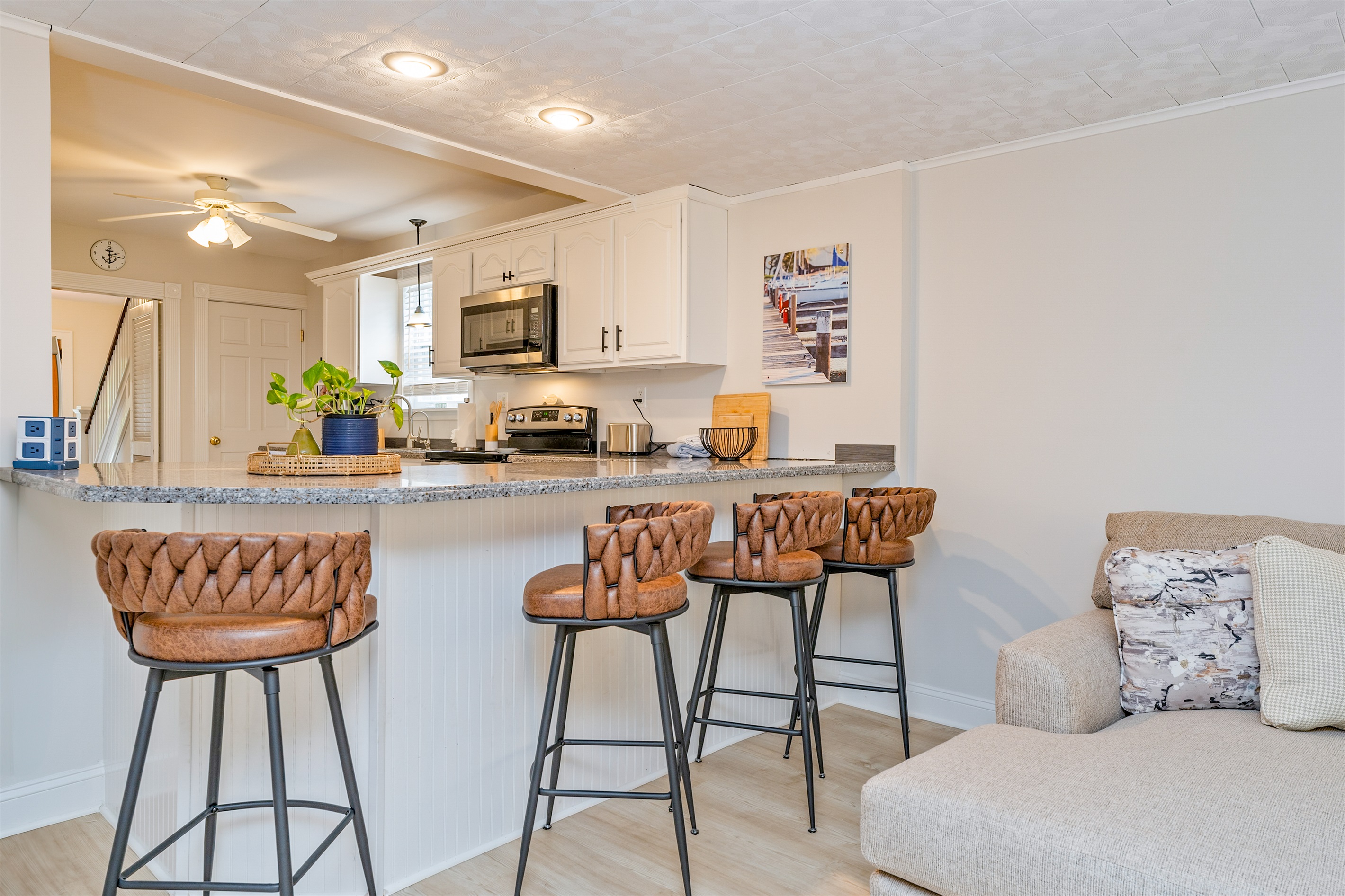 Enjoy cooking in the modern kitchen while family and friends gather at stylish bar looking into the living room —ideal for entertaining and casual dining.