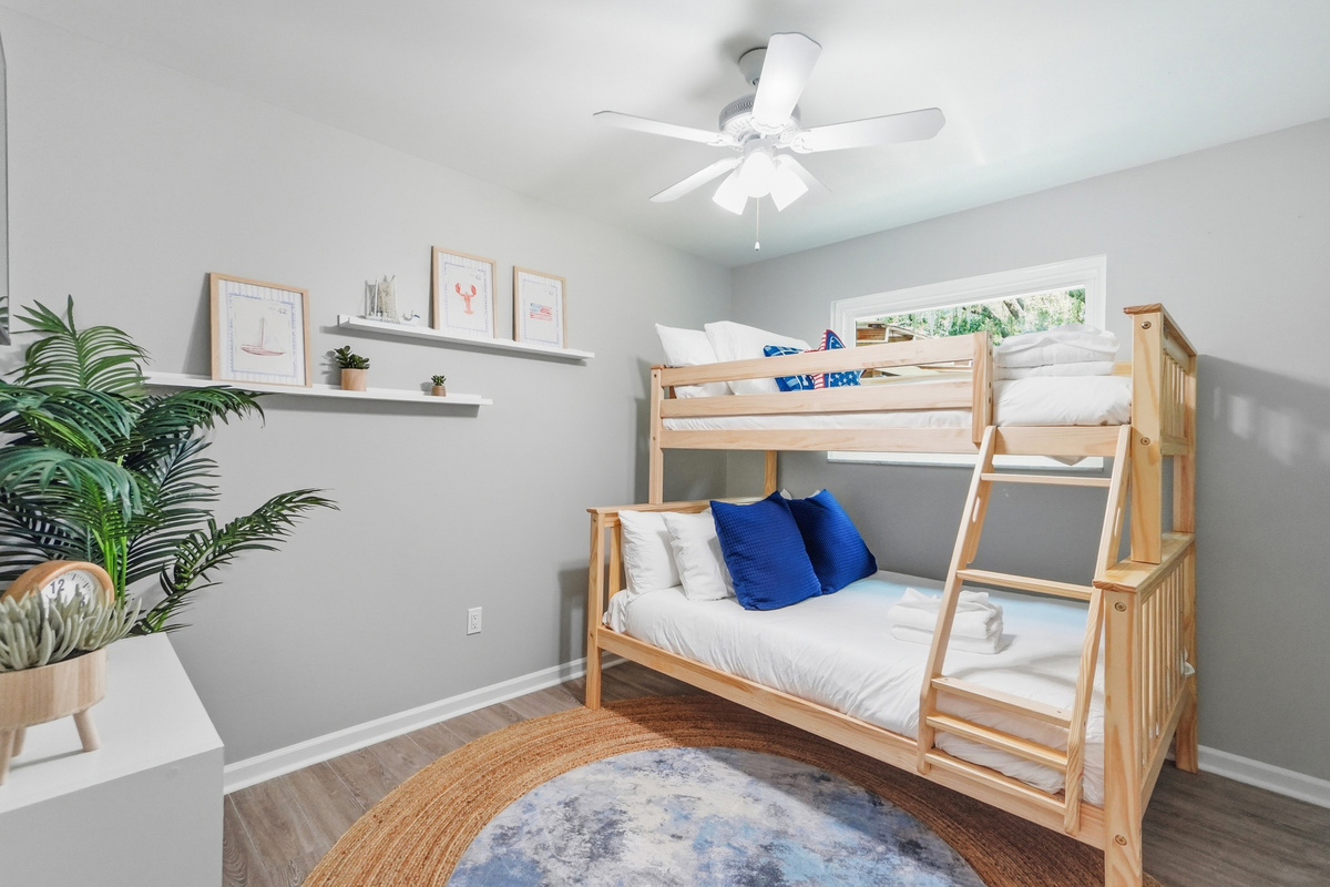 The nautical-inspired bunk room provides a fun and comfortable sleeping arrangement for families or groups.
