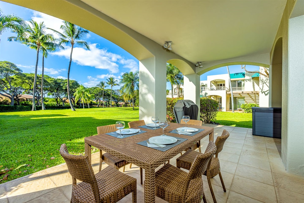 the lanai dining area looks out onto the large lawn. Note the BBQ was removed from all lanais May 2024. There are now common BBQ areas around the property.