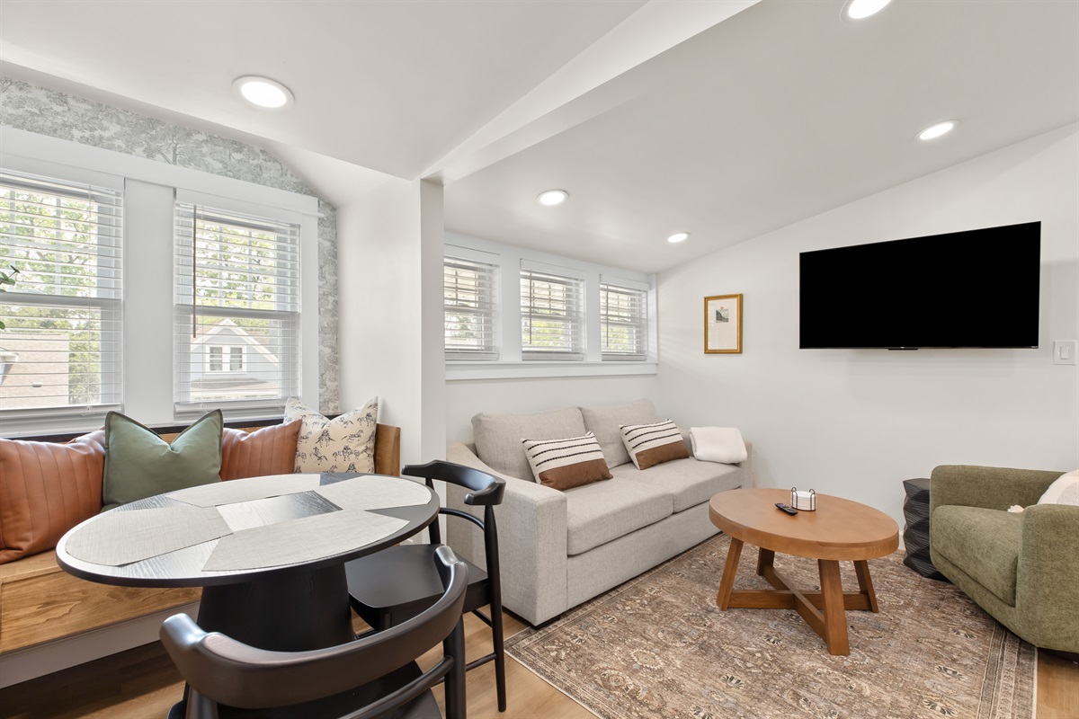 Cozy and inviting living area with a smart TV, plush seating, and plenty of natural light—perfect for relaxing after a day out.