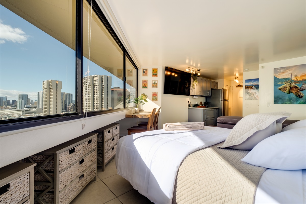Awaken to skyline views and golden island light streaming into your modern Waikīkī retreat. Featuring a cozy king bed, stylish décor, and breathtaking city and ocean vistas — this suite offers the perfect blend of comfort and island elegance just moments f