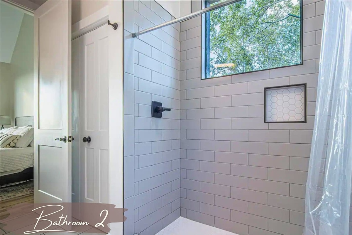 A bright, spacious walk-in shower and natural light make this bathroom feel welcoming and fresh.