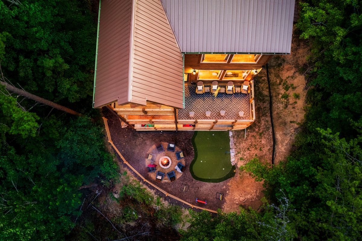 Luxury cabin with multiple decks , hot tub, and backyard with string lights,  fire pit and mini golf 