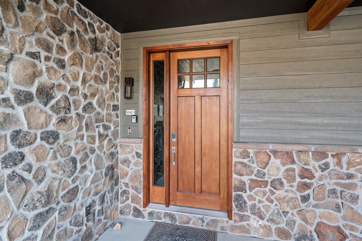 Private front entry with rustic stone and wood accents