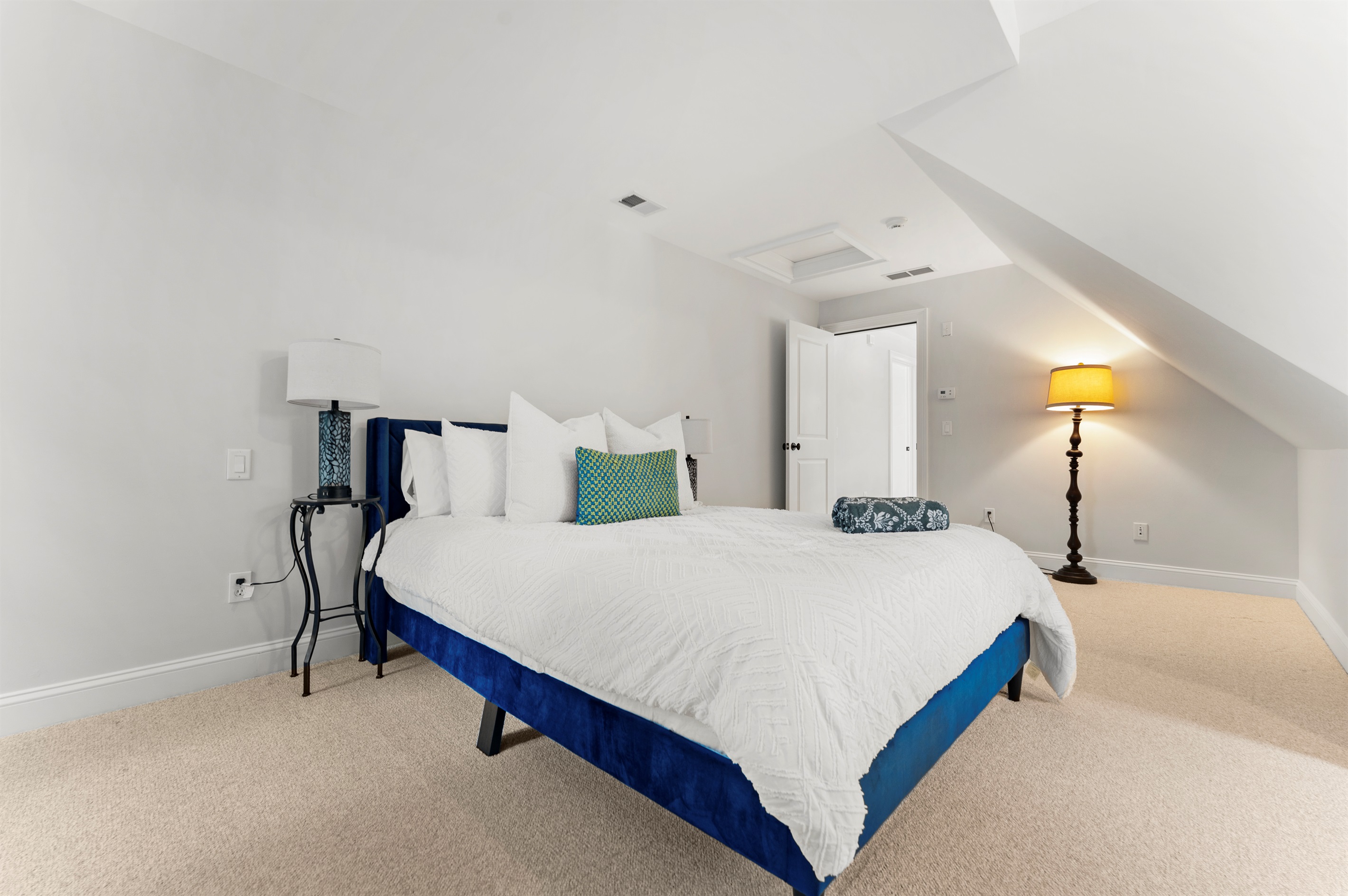 Upstairs Bedroom 4 offers a restful escape with a plush queen bed