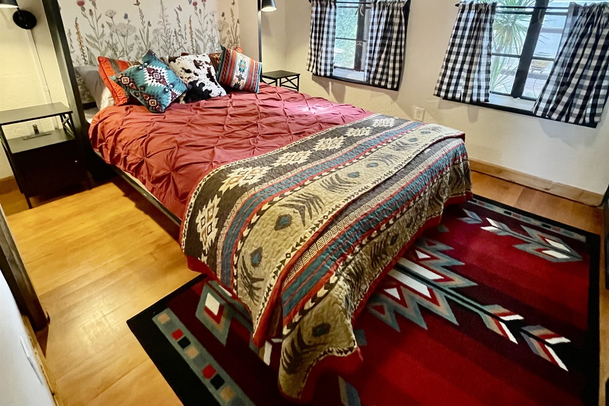 Wake up to garden views in this cozy queen bed with southwestern charm.