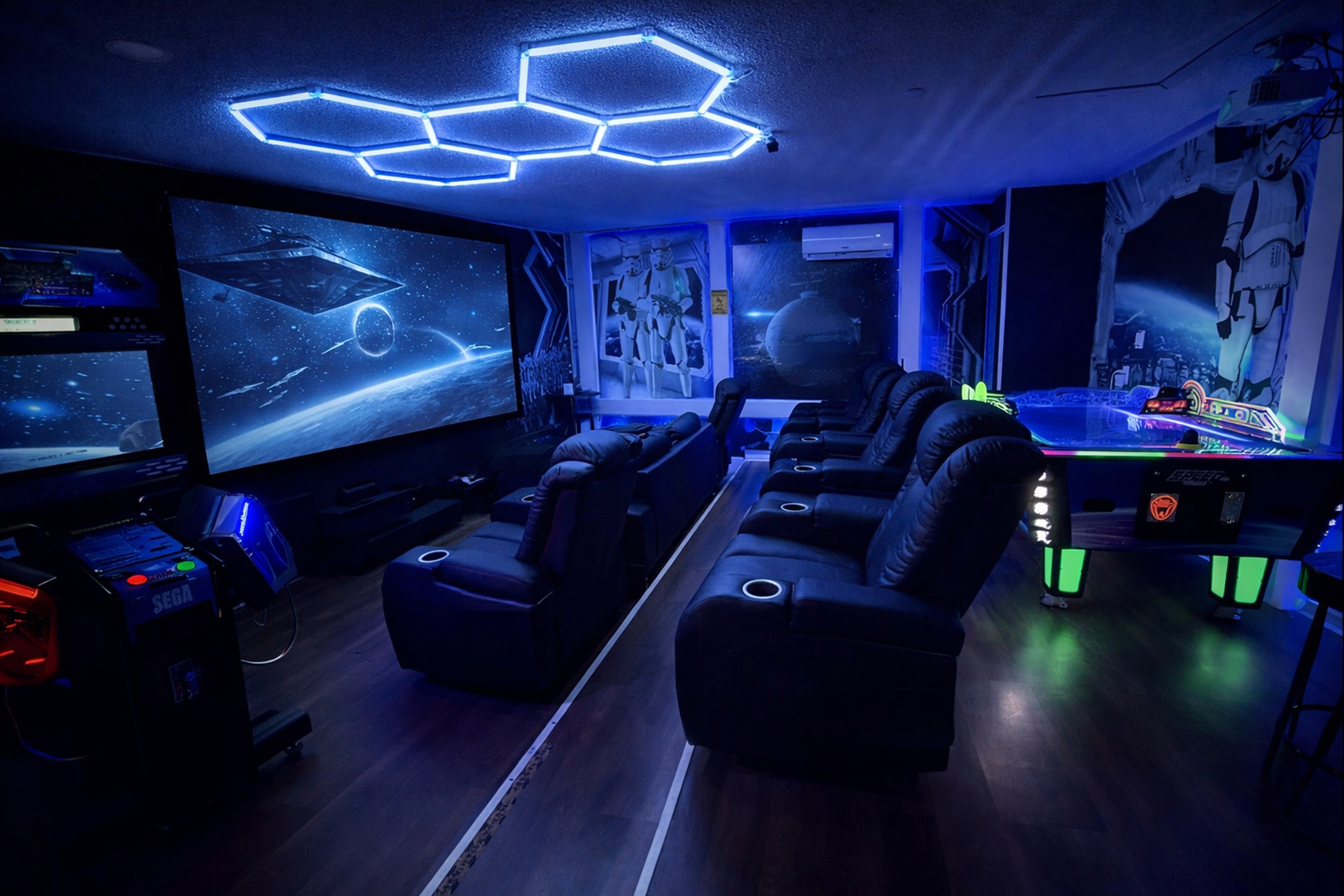 A modern home theater with reclining seats and space-themed lighting for an immersive movie experience.