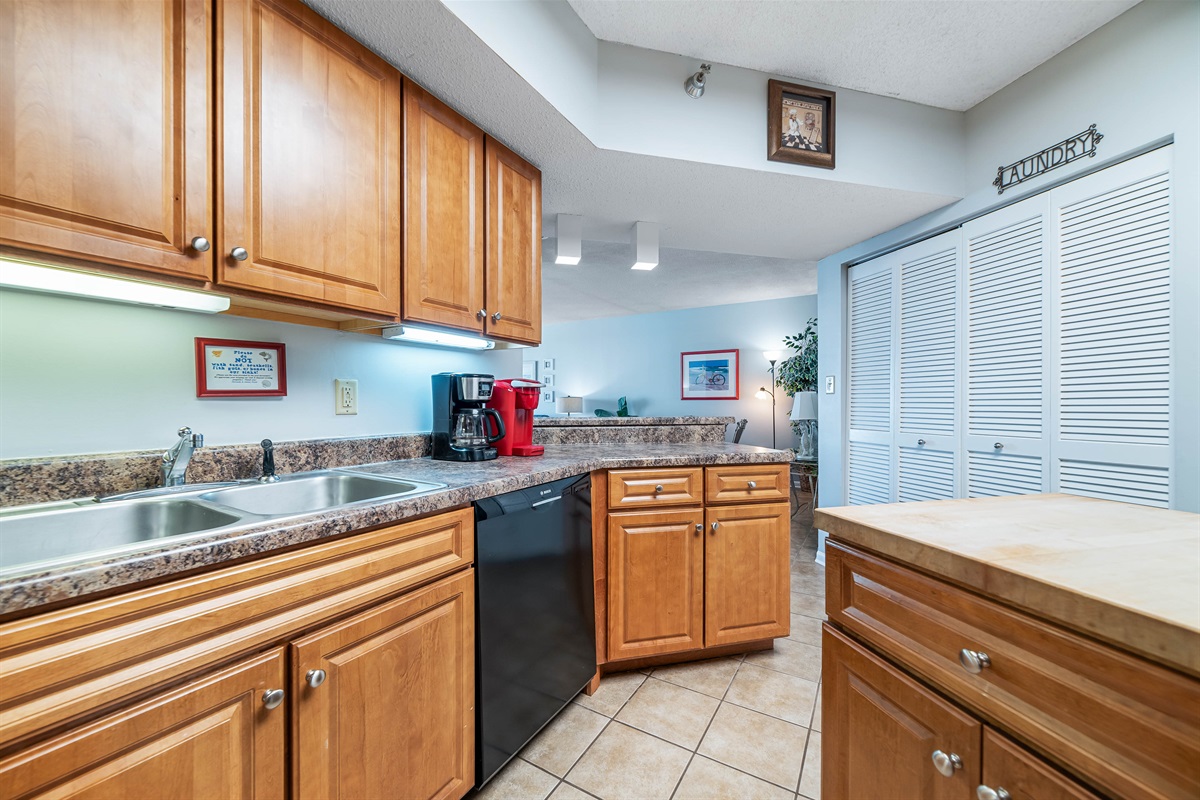 Updated kitchen with stainless steel appliances, quartz countertops, and a contemporary backsplash, offering both functionality and aesthetic appeal.