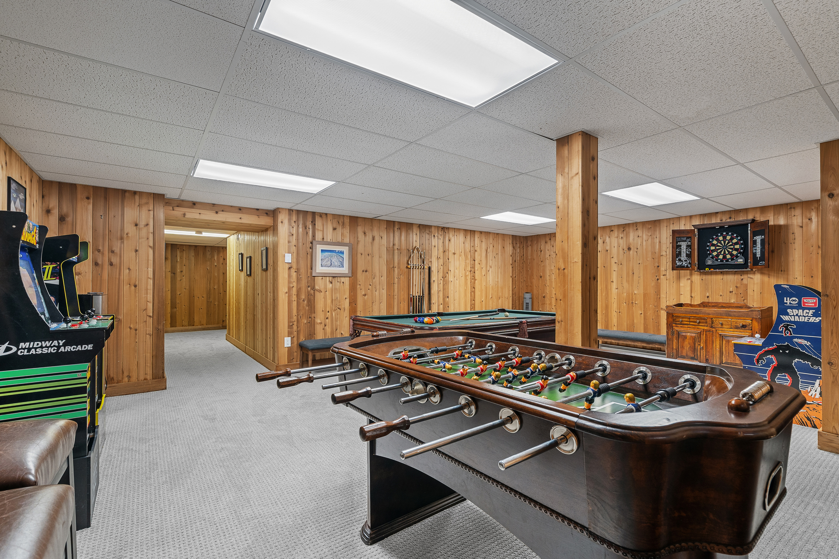 Foosball table, arcade games and dartboard in the family game room, Winhall Vermont