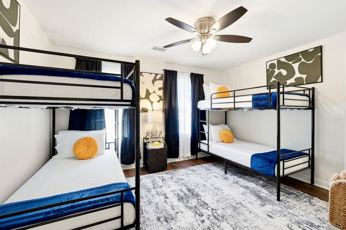 Cozy second-level bedroom with two bunk beds, each with blankets and a Roku TV. First room you see at the top of the stairs. Includes 4 full-body towels, 4 washcloths, and 2 hand towels for your stay.