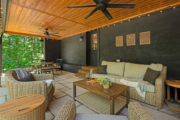 This covered patio is one of our favorite spaces with comfortable furniture for casual conversations or dining while enjoying peace in the foothills of NC Mountains.