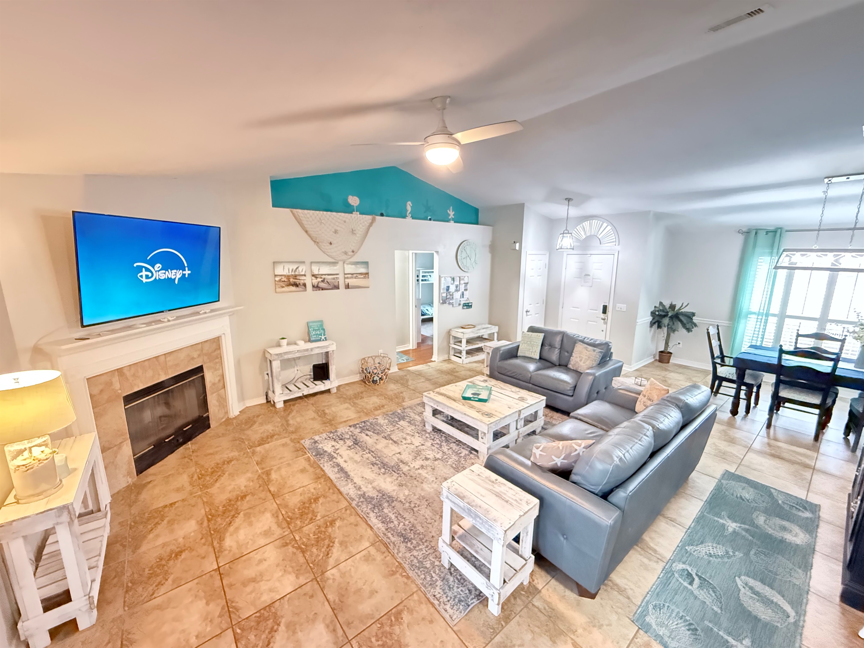 Our main living room featuring a 65" 4K HDR Roku TV, Leather furniture, and plenty of board game space. Bring the streaming credentials.