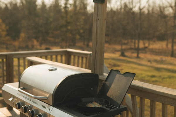 Propane gas grill on the deck off of the dining area