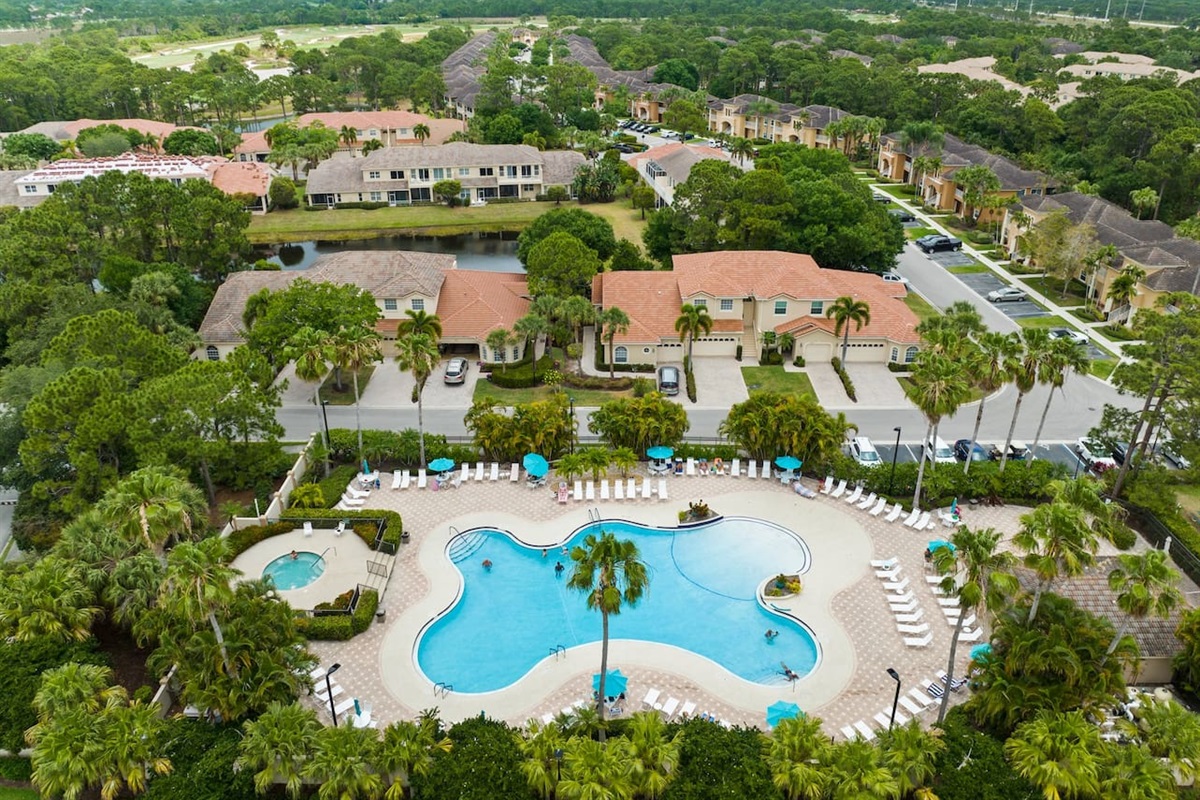 Aerial view of the community amenities featuring the pool, spa, sundeck, and beautifully maintained grounds.