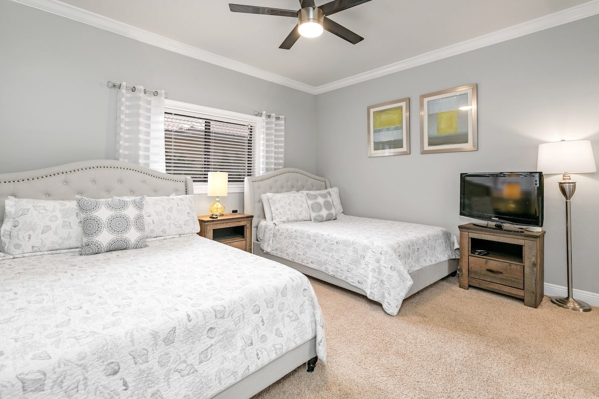 Bedroom 2: Queen and twin beds with TV and ceiling fan