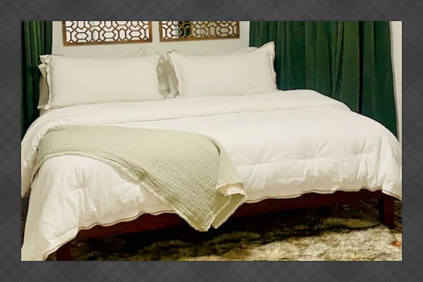 Stylish bedroom with comfortable bedding and cozy decor.