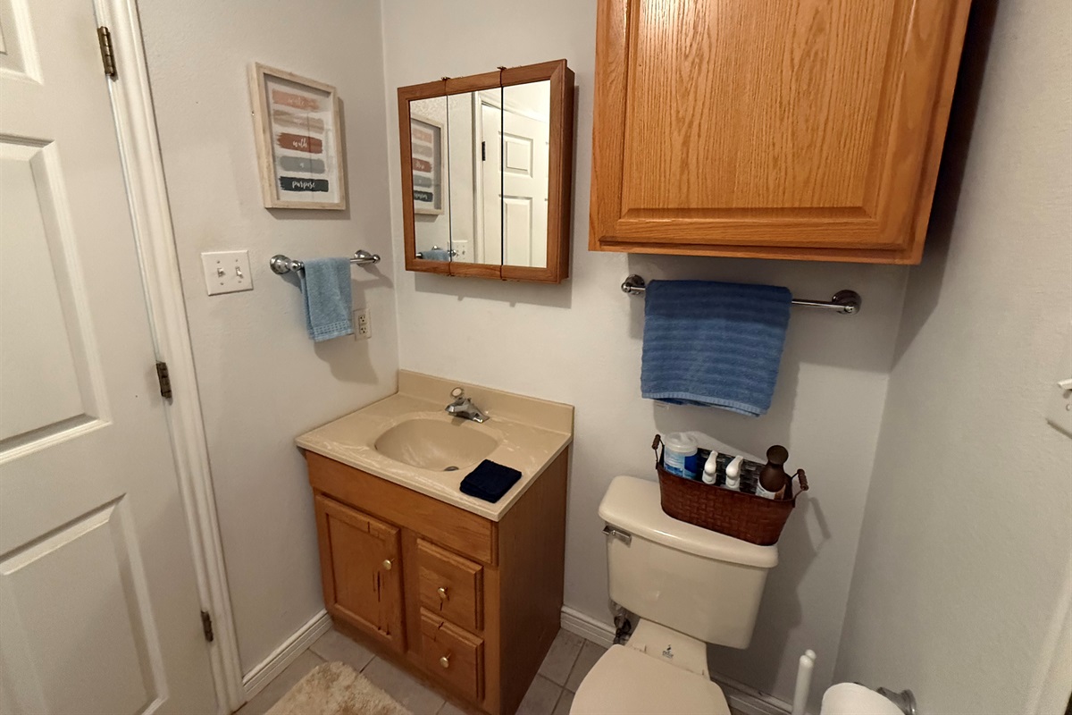 Well-lit vanity with toiletries provided.