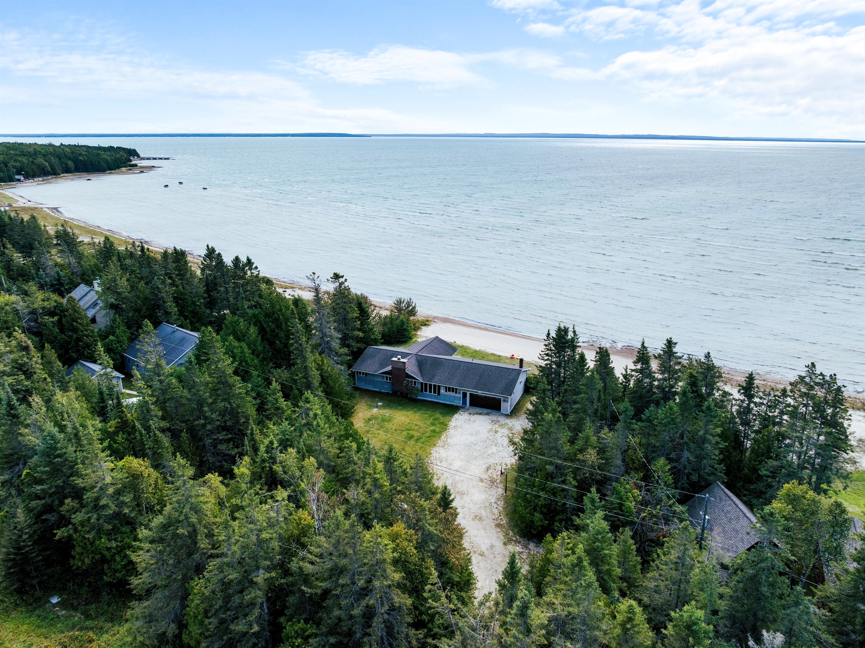 Towering pines and a soft, sandy beach welcome you