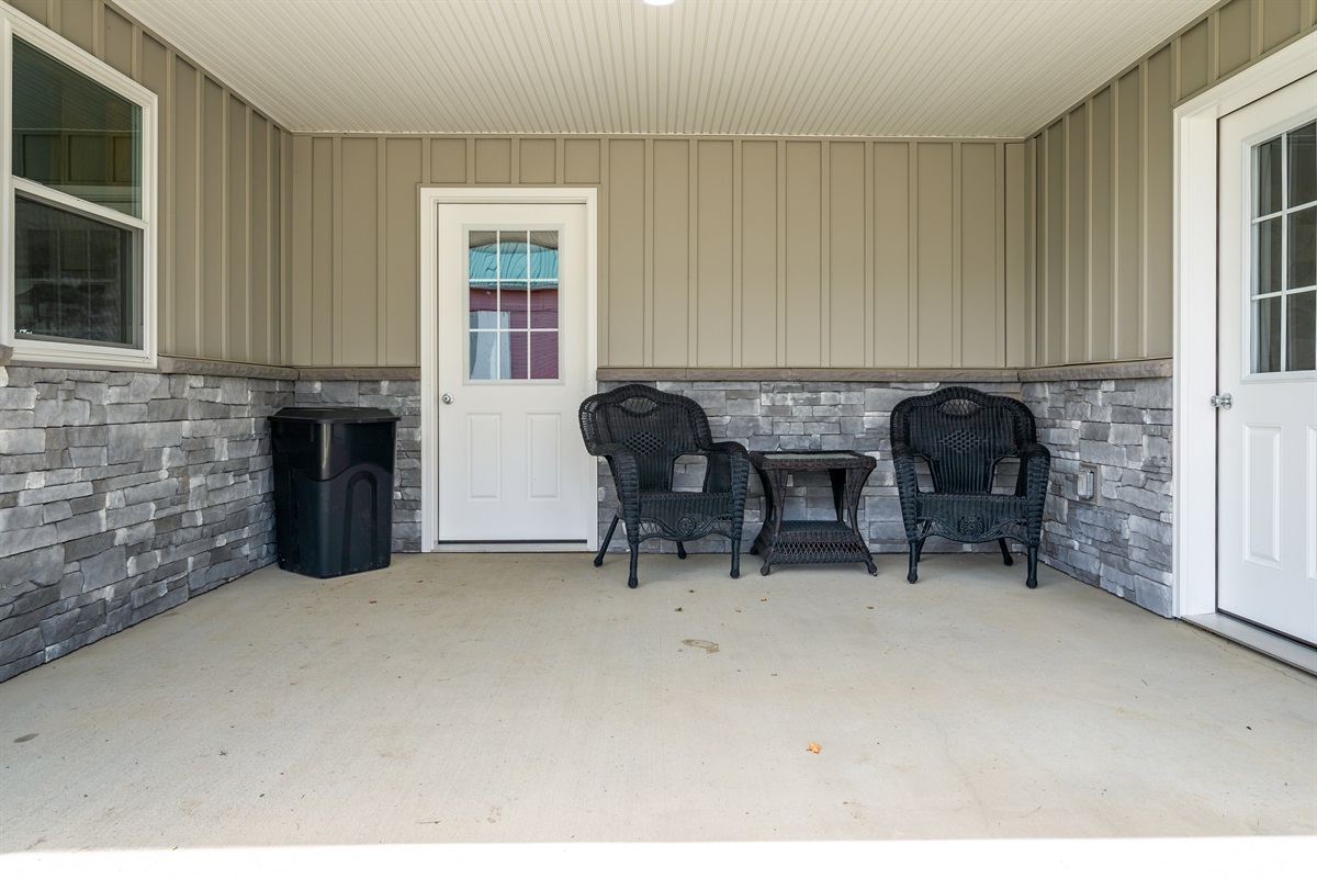 Covered porch with cozy seating—perfect for morning coffee or a quiet evening chat