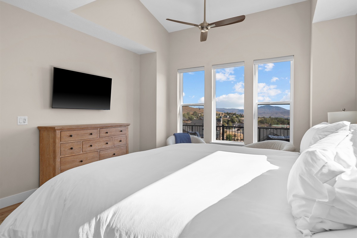 Spacious primary bedroom with mountain views, designed for comfort and relaxation.