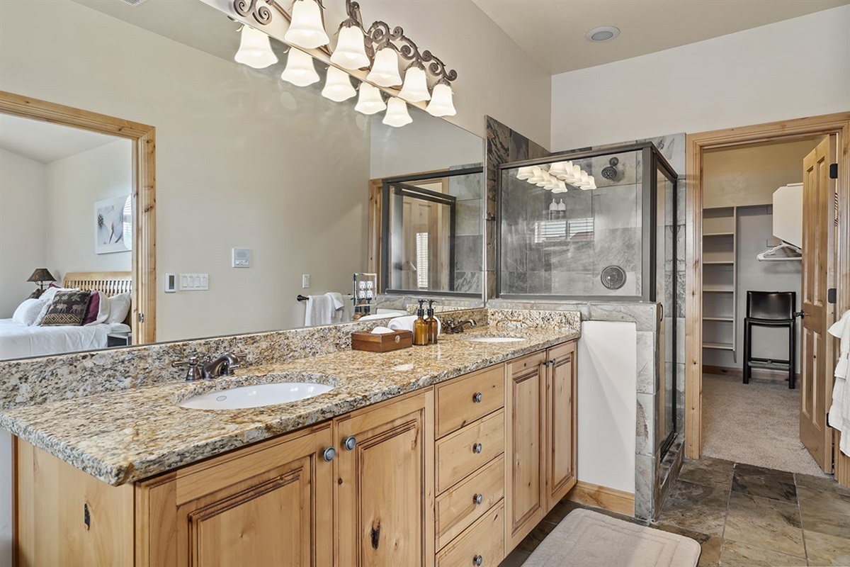 Spa-like bathroom with dual vanity and upscale finishes, offering both style and convenience.