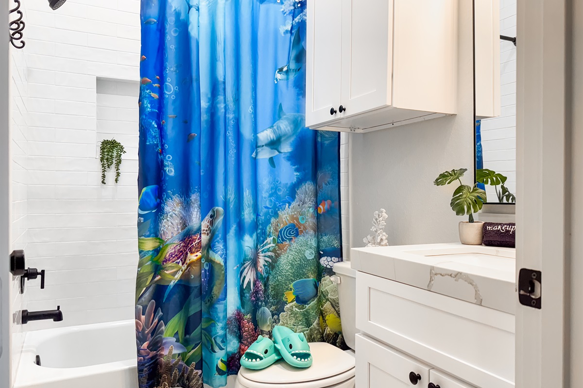 The bathroom has a shower/tub combo.