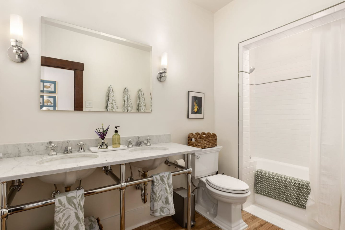 spacious bathroom with 2 sinks and shower nook, all new fixtures