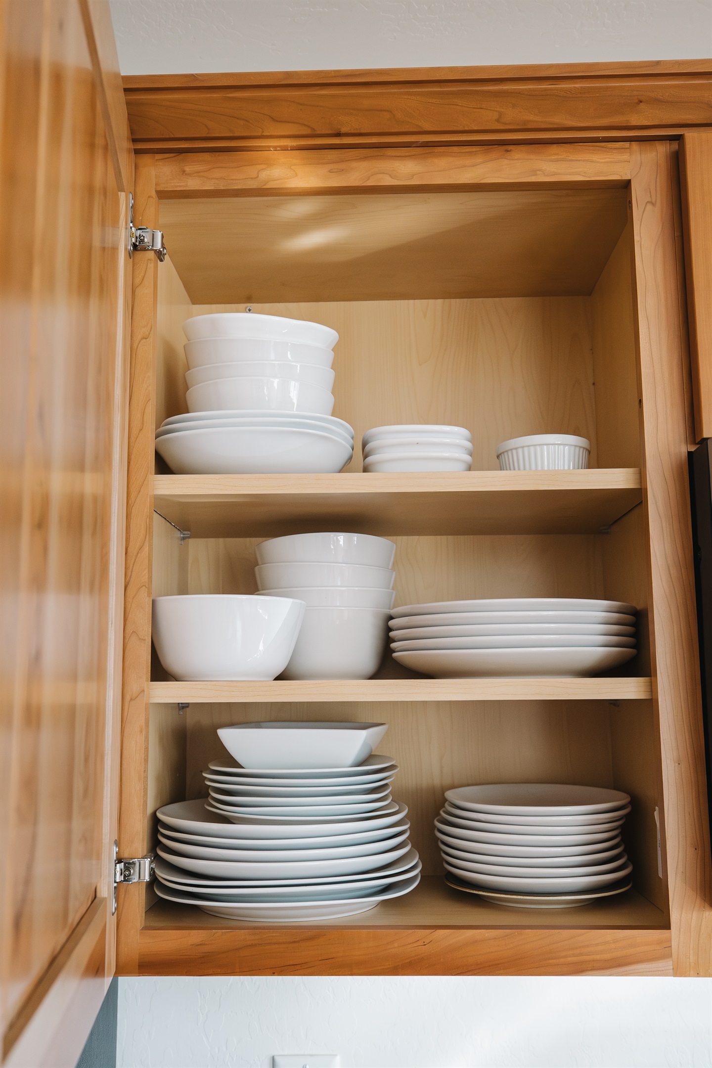 Fully stocked kitchen with complete dishware, bowls, and serving pieces—perfect for home-cooked meals, family dinners, and extended stays.