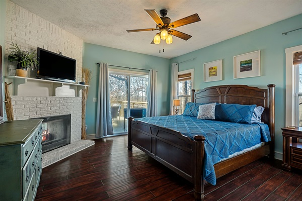 Primary suite with views, deck access, and fireplace