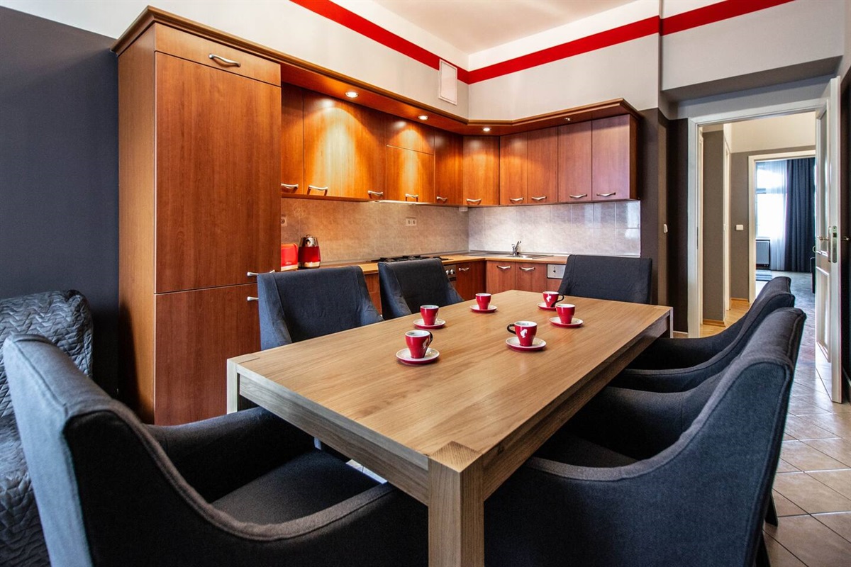 Fully equipped kitchen with large dining table and comfy chairs. 