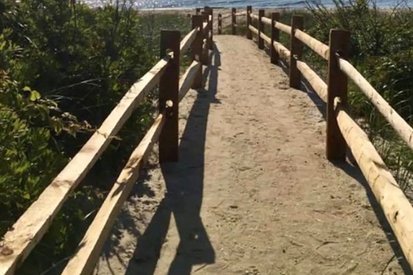 This scenic sandy path with rustic wooden railings leads you directly to the beach. It provides a short and easy walk from the property to the beautiful shoreline and ocean waves.