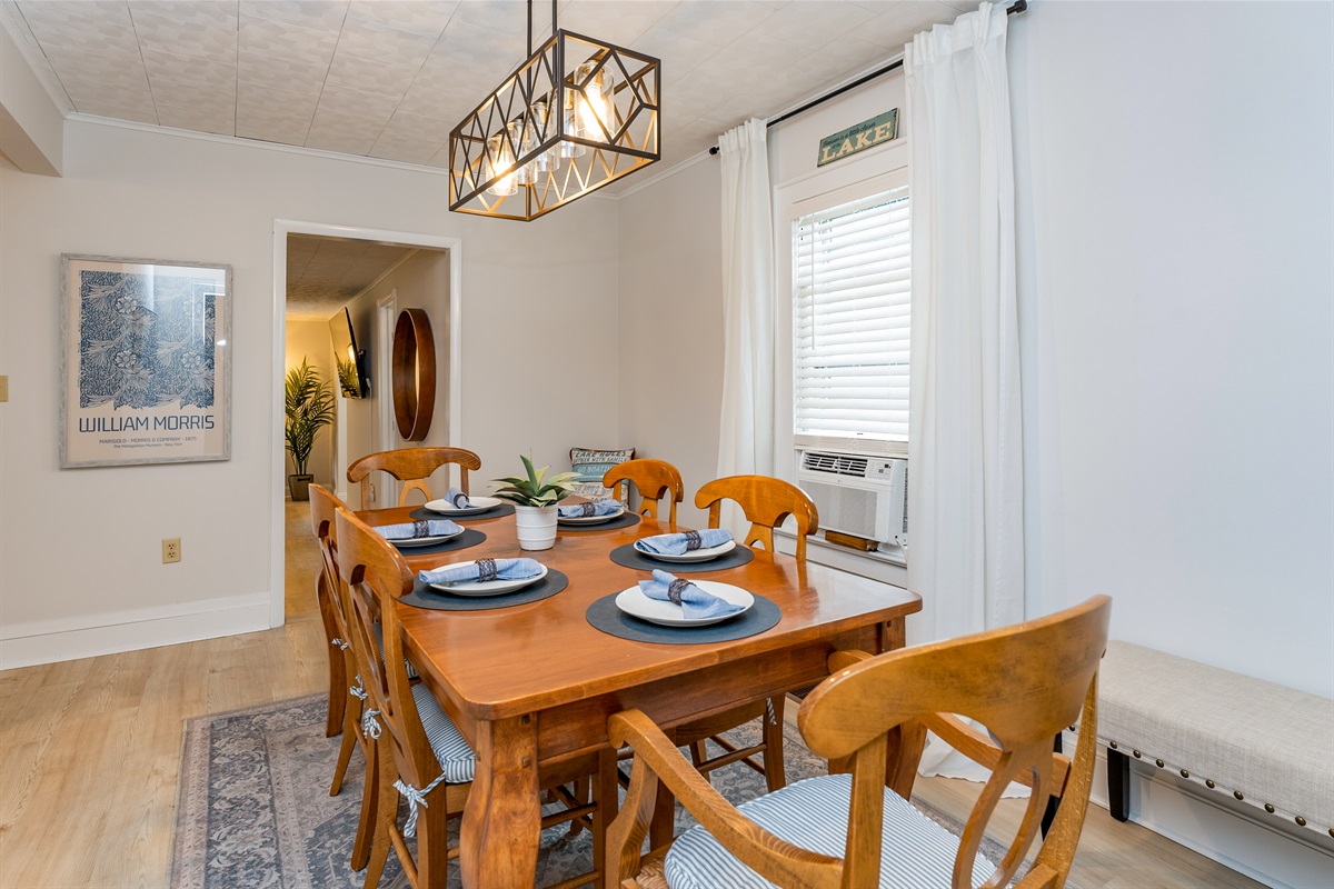 Open-concept dining area seamlessly connects to the cozy living space, ideal for both intimate dinners and lively group gatherings.