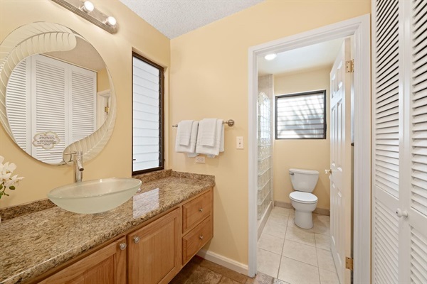 Second bathroom - features a walk-shower, vanity, and closet for additional storage