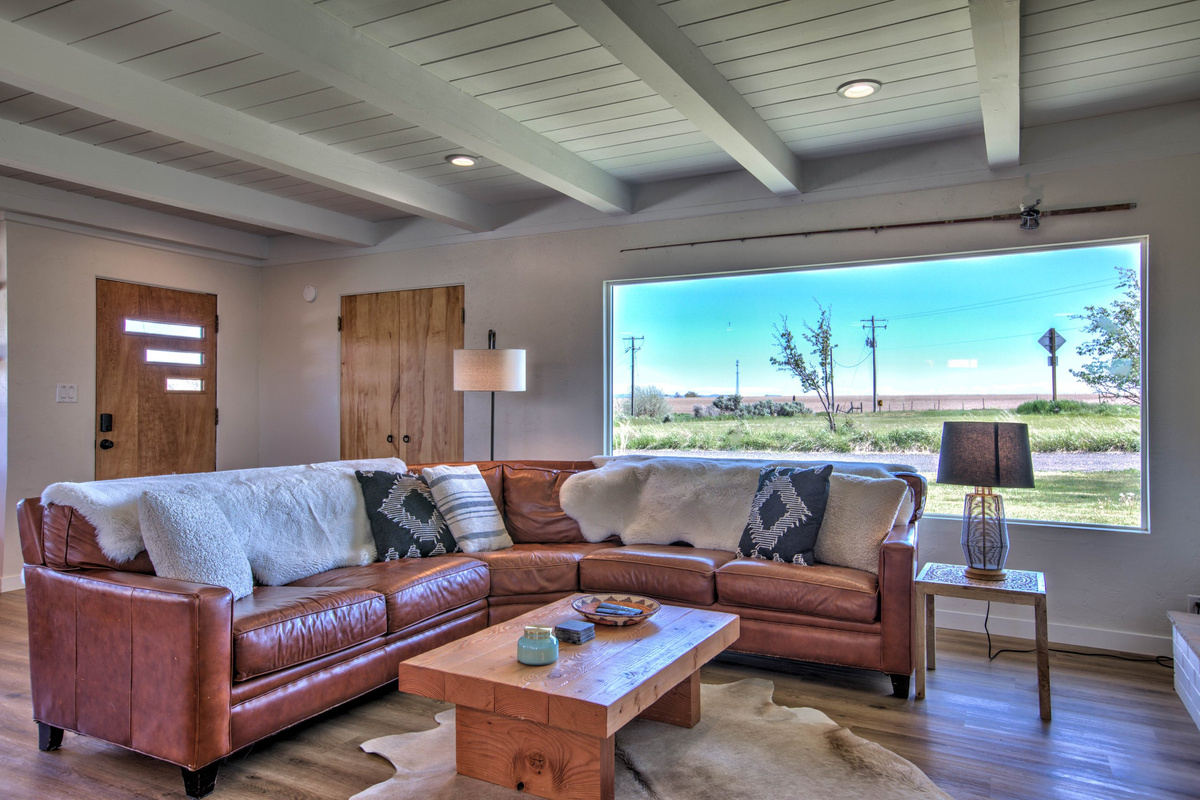 Comfortable living room with leather seating and sweeping country views