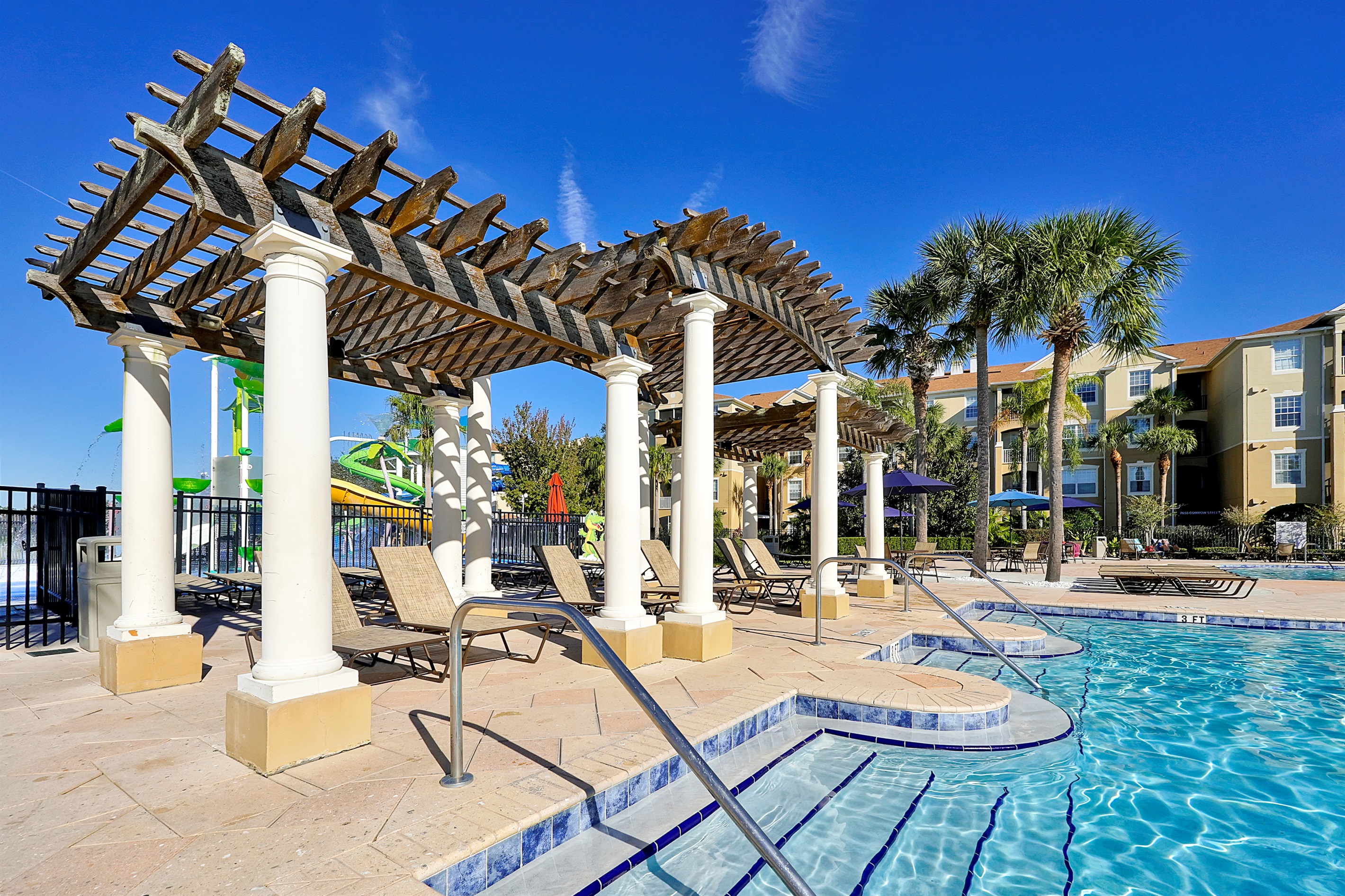 Relax poolside under shaded pergolas while the kids play nearby