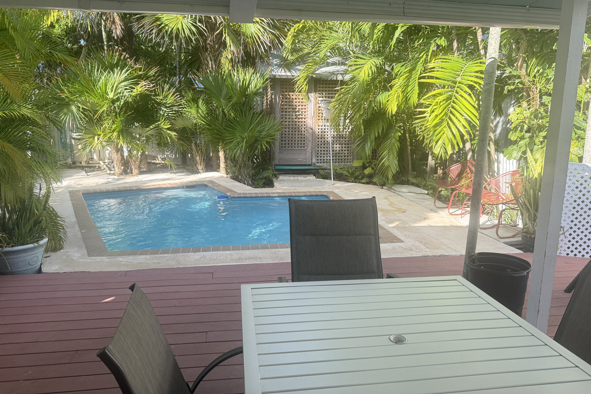 Unwind in your private tropical oasis, where lush greenery surrounds a serene pool. Sip your morning coffee or enjoy an al fresco meal on the spacious deck.