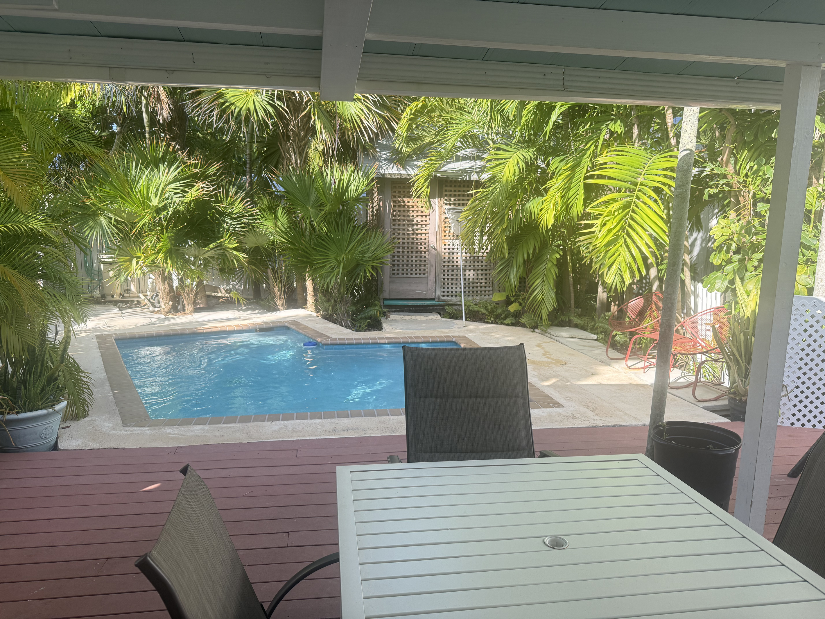 Unwind in your private tropical oasis, where lush greenery surrounds a serene pool. Sip your morning coffee or enjoy an al fresco meal on the spacious deck.