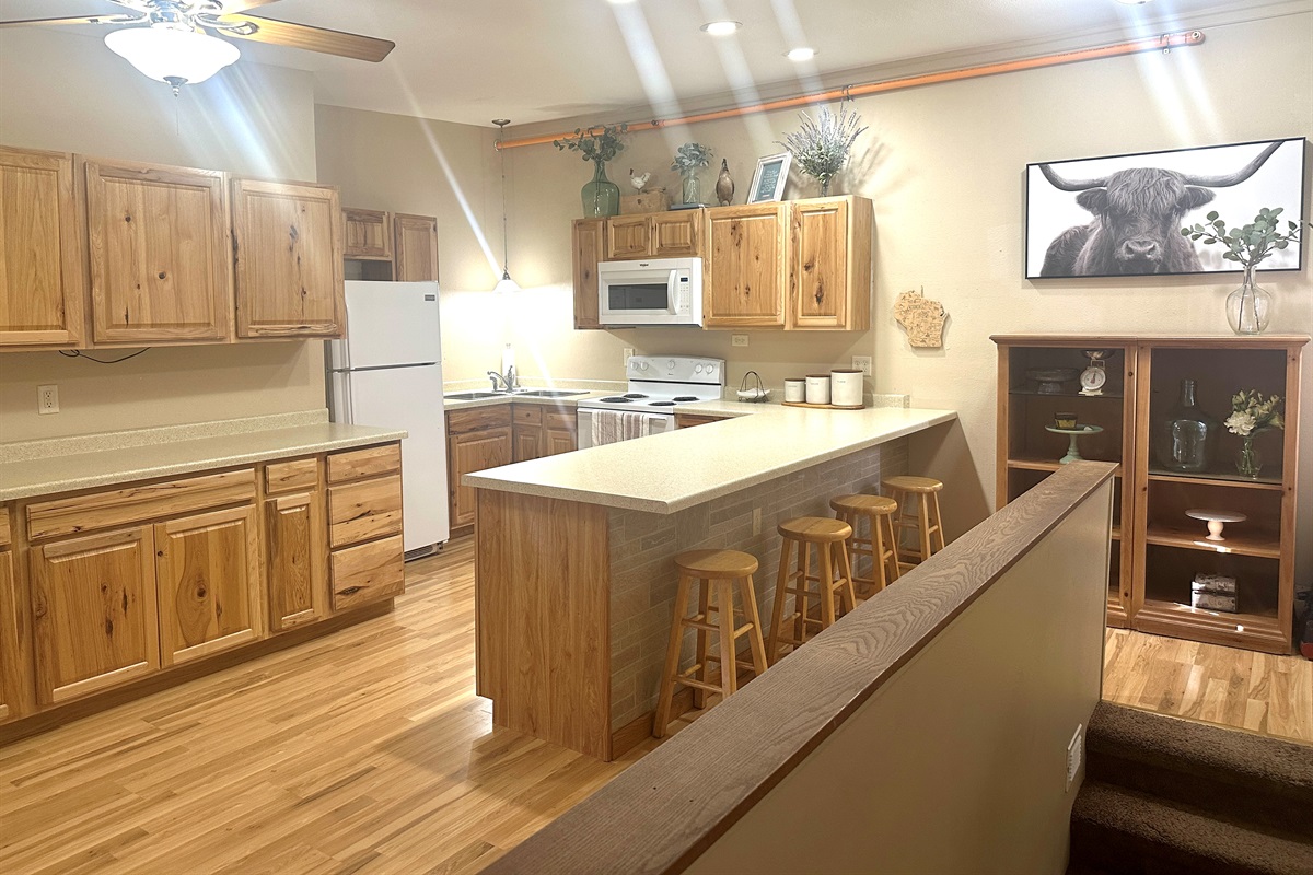 The large kitchen is fully stocked for all your cooking and gathering needs.