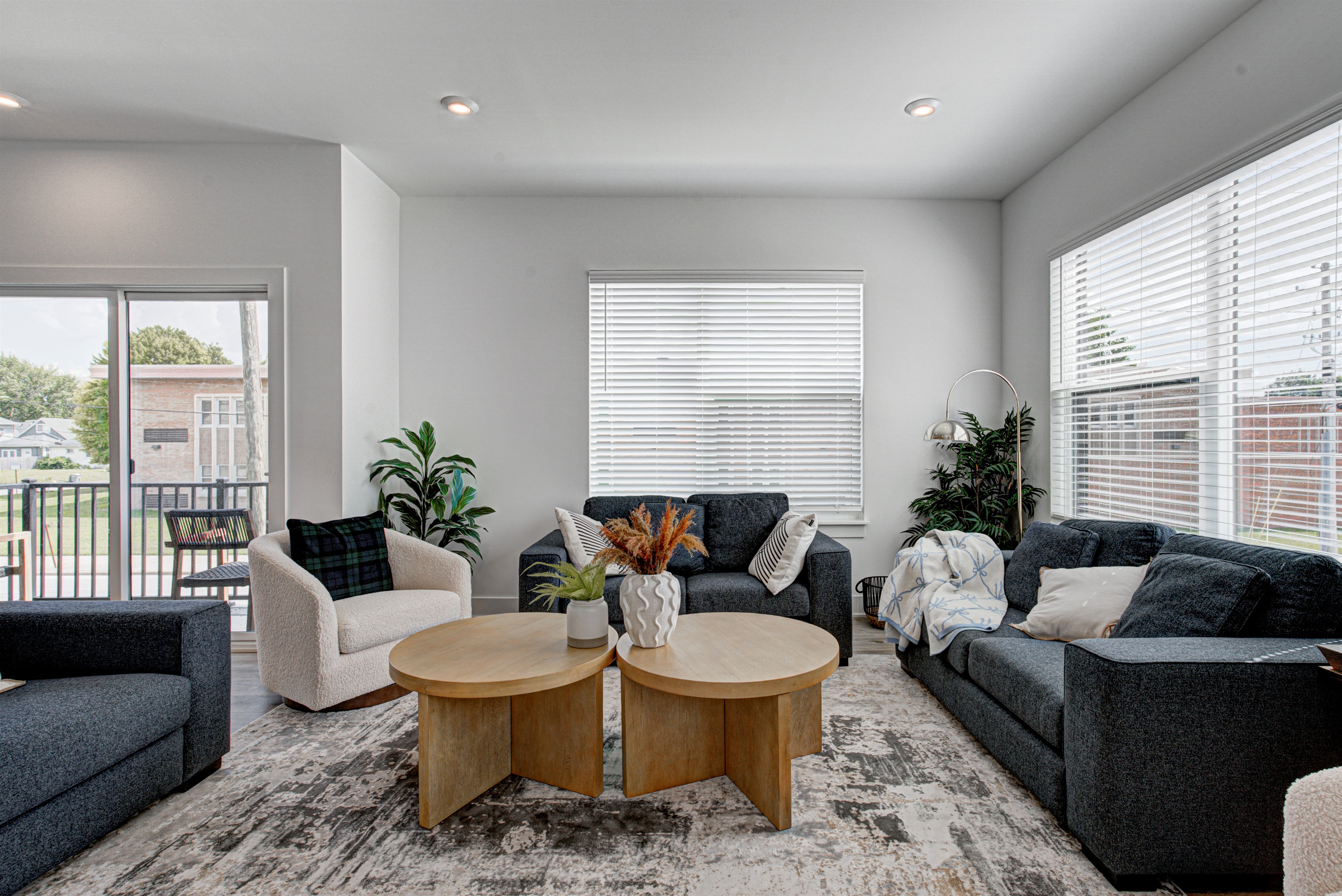 Enjoy a designed open-concept space with a modern kitchen equipped with quartz countertops, stainless steel appliances, and all essentials for home cooking. 