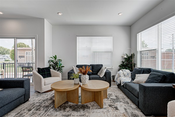 Enjoy a designed open-concept space with a modern kitchen equipped with quartz countertops, stainless steel appliances, and all essentials for home cooking. 