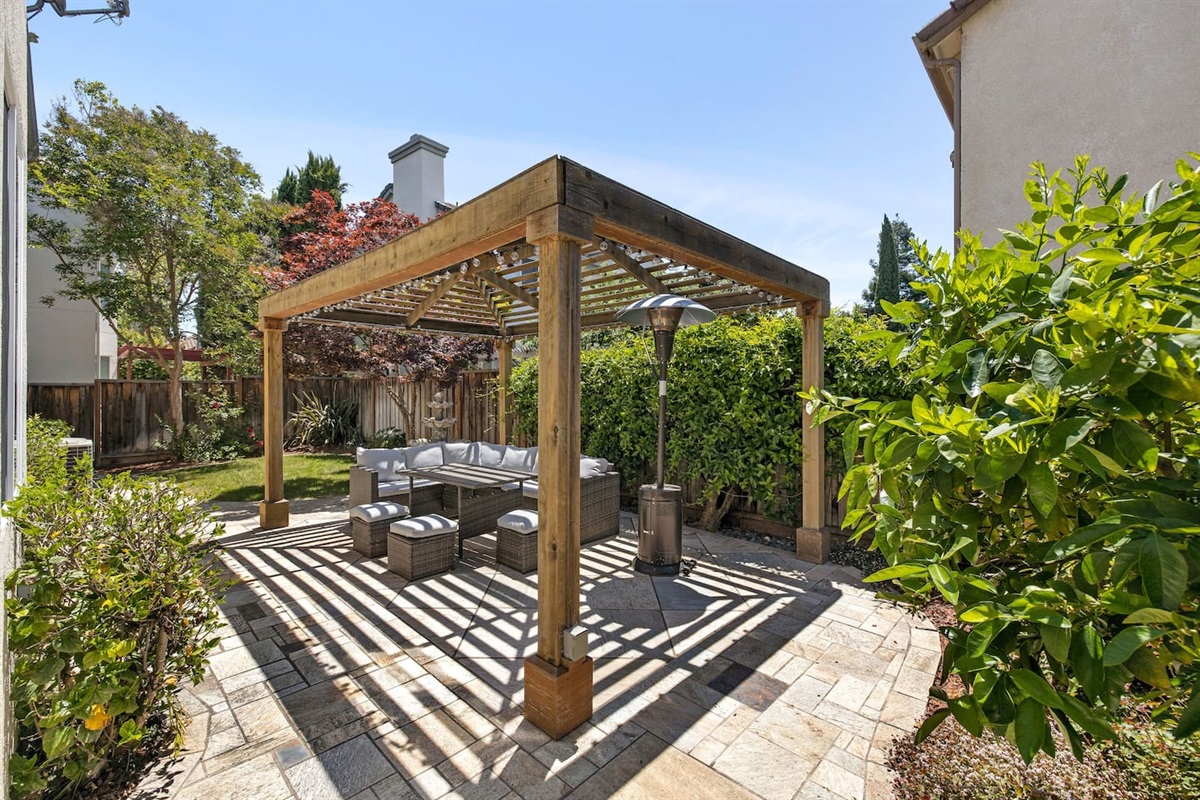 Relax and enjoy the outdoors in this charming backyard.