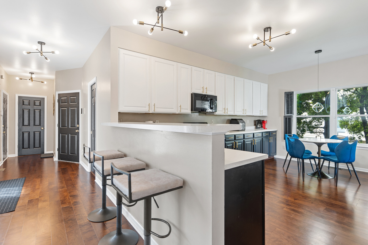 Pull up a stool and join the conversation - this bar area bridges the kitchen and living room, making it the perfect spot to sip, snack, or keep the cook company.