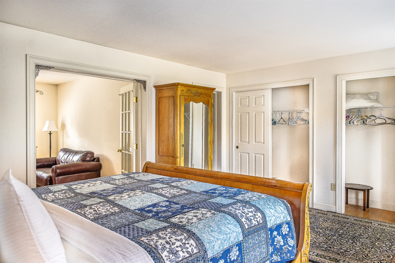 The expansive Primary Suite features a King sleigh bed, "his and hers" closets, and a private sitting room. With an en suite bathroom, blackout blinds, and dedicated summer AC, this is the ultimate restful retreat in Southwest Harbor.