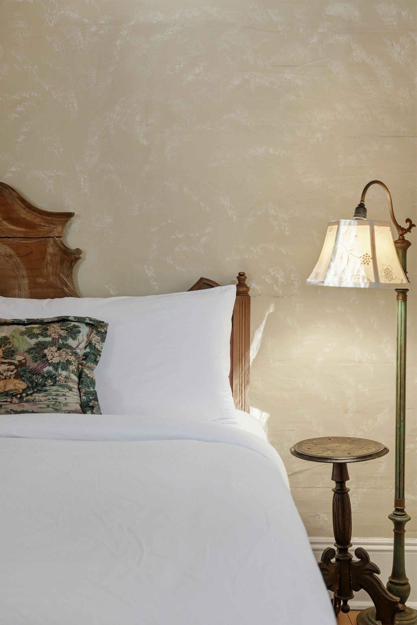 Plush bed dressed in crisp linens for a restful night’s sleep