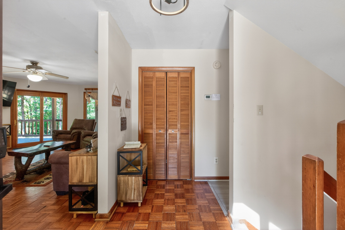 Entryway Charm: Bright and welcoming space with natural wood accents and inviting views!