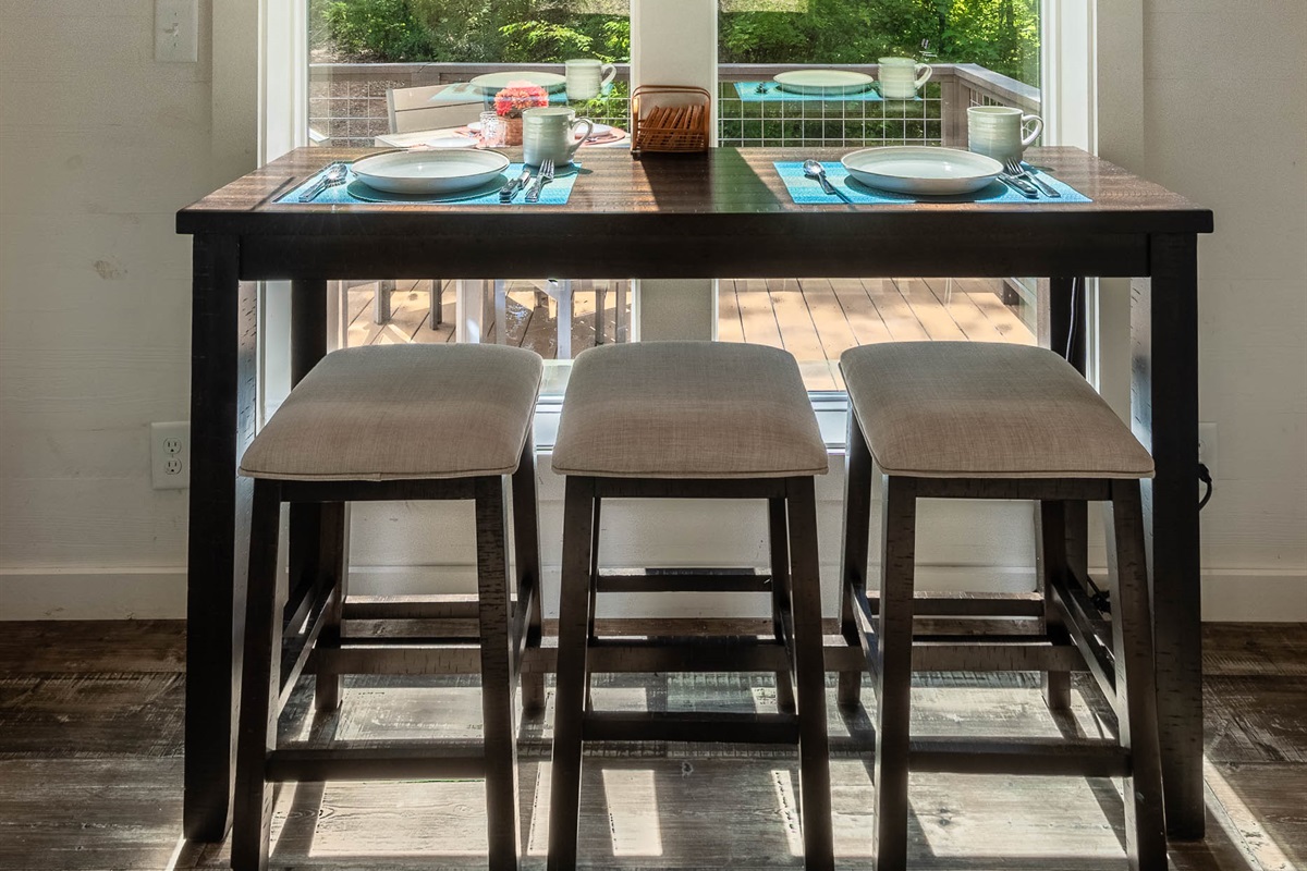 Gather at the counter-height table for meals, games, or coffee with a view of the front yard.