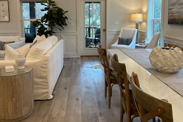 Living area (L)  dining area (R) with door to the screened in porch
