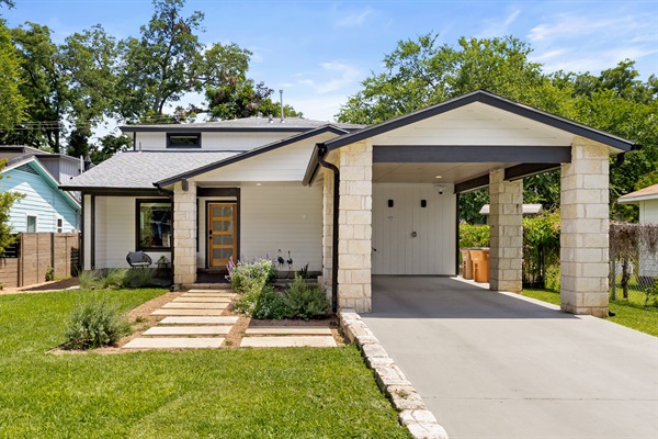 Enjoy a stylish entrance with lush greenery and inviting stone pathways!