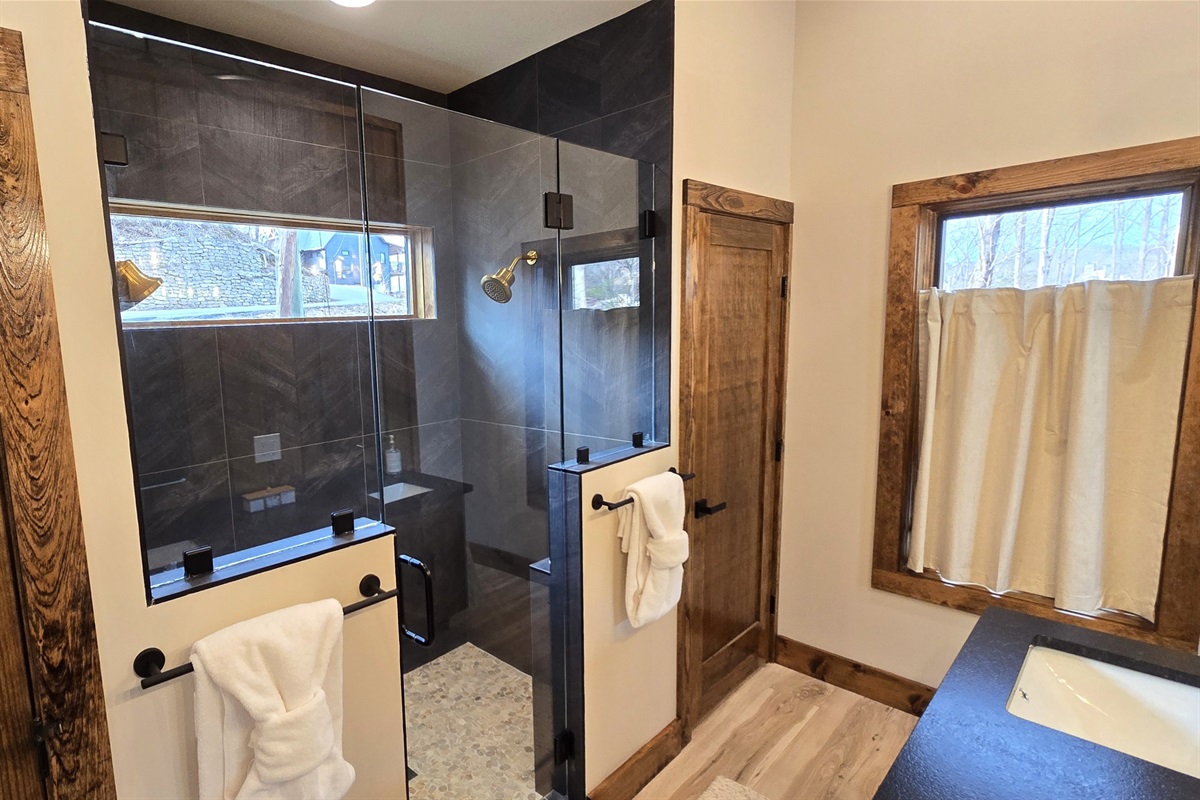 Custom walk-in shower, laundry closet with full size all in one washer dryer unit 